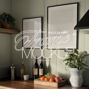 May include: Two black picture frames with white mats hanging on a green tiled wall in a kitchen. The frames are empty and ready for your photos or artwork. The kitchen also features a wooden shelf, a black range hood, and a vase with green plants.