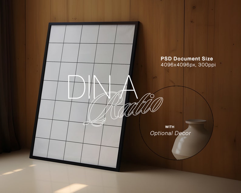 May include: A black framed poster with a white grid pattern and the text "DINA Ratio" in white cursive lettering. The poster is leaning against a wood wall with a white ceramic vase to the right.