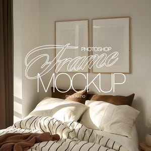 May include: A bedroom mockup featuring two framed art prints above a bed with white bedding and a striped duvet. The bed has brown pillows and a brown knitted throw. The text "Photoshop Frame Mockup" is overlaid on the image.