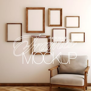 May include: A set of six wooden picture frames in various sizes, arranged on a white wall above a light gray armchair with wooden legs. The frames are empty and ready for your photos or artwork.