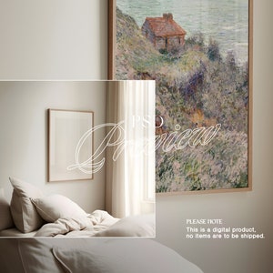 May include: A digital illustration of a painting depicting a small house on a cliff overlooking a body of water. The house is painted in shades of brown and red, and the water is a light blue. The painting is framed in a wooden frame and is hanging on a white wall.
