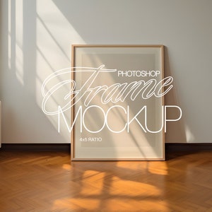 May include: A wooden frame mockup with a 4x5 ratio, sitting on a hardwood floor with natural light streaming in from a window. The text "Photoshop Frame Mockup" is written in white on the frame.