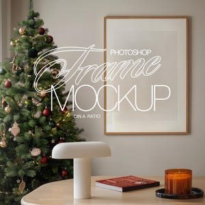 May include: A wooden frame with a white mat and a white background. The frame is hanging on a wall next to a decorated Christmas tree. The text "PHOTOSHOP FRAME MOCKUP DIN A RATIO" is written in white on the frame.