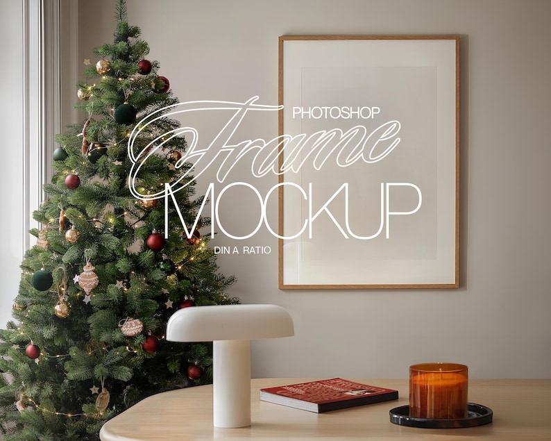 May include: A wooden frame with a white mat and a white background. The frame is hanging on a wall next to a decorated Christmas tree. The text "PHOTOSHOP FRAME MOCKUP DIN A RATIO" is written in white on the frame.