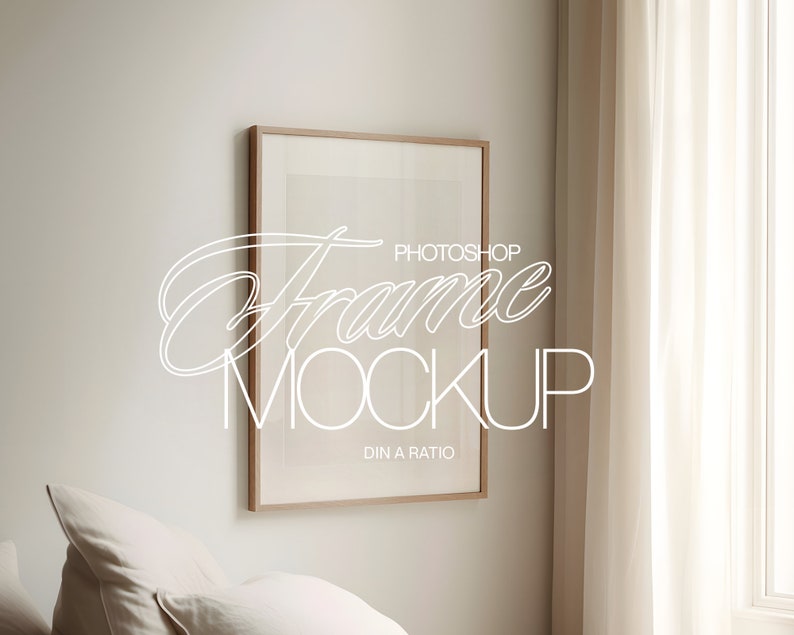 May include: A light brown wooden frame with a white mount and a white background. The frame is hanging on a white wall. The text "Photoshop Frame Mockup DIN A Ratio" is written in white on the frame.