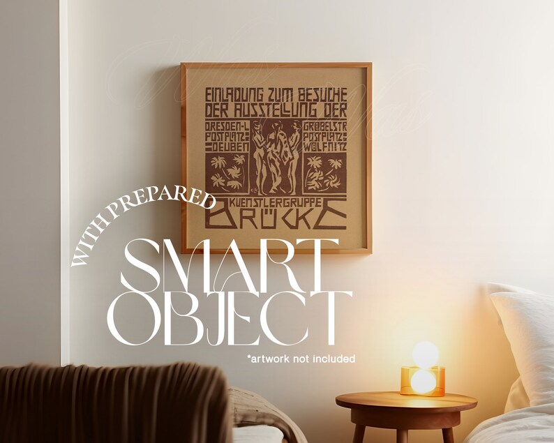 May include: A framed print of a vintage poster with the text "EINLADUNG ZUM BESUCHE DER AUSSTELLUNG DER" and "KUENSTLERGRUPPE BR"C"KE". The poster is in a brown wood frame and is hanging on a white wall. The text "WITH PREPARED SMART OBJECT *artwork not included*" is written in white text below the frame.