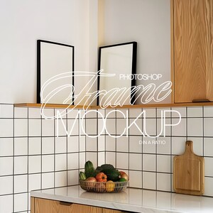 May include: A white kitchen with a white tiled backsplash, a wooden countertop, and two black picture frames on a wooden shelf. The frames are empty and ready for your photos.  The text "PHOTOSHOP FRAME MOCKUP DIN A RATIO" is written in white on the image.