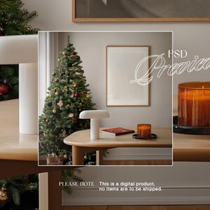May include: A white table lamp with a white shade sits on a wooden table next to a decorated Christmas tree. A framed picture hangs on the wall behind the table. The text "PSD Preview" is written in white on a black background.