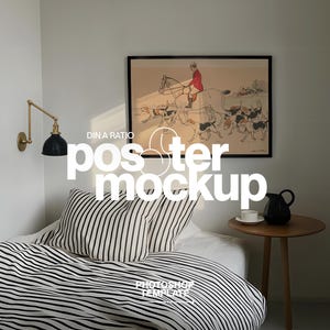 May include: A bedroom scene featuring a bed with black and white striped bedding and pillows. A framed artwork hangs above the bed. A small wooden side table holds a black pitcher and a white teacup. The text "DIN A RATIO poster mockup" is visible.
