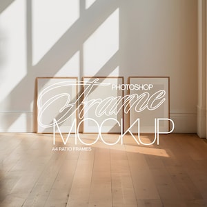 May include: Three wooden picture frames with white mounts are leaning against a white wall. The frames are empty and ready for your photos. The frames are in a room with a wooden floor and natural light.