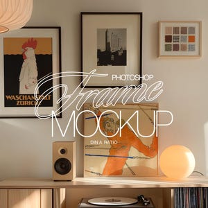 May include: A framed art print with a colorful abstract design hangs on a wall above a wooden shelf. The shelf has a record player, a speaker, and a lamp on it. The print is in a light wood frame with a white mat.