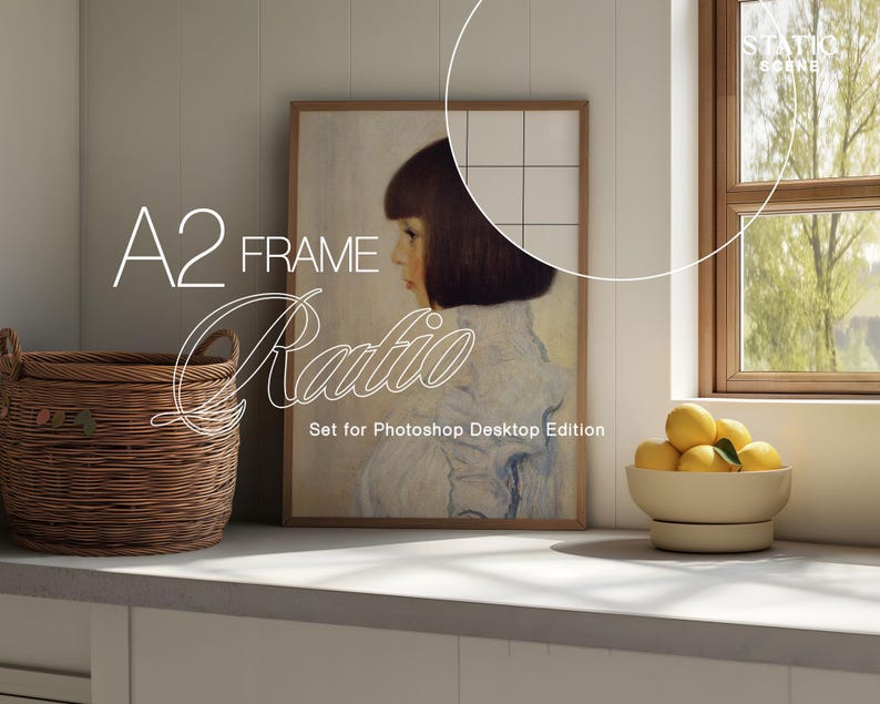 May include: A framed artwork featuring a portrait of a woman with short dark hair and a light-colored dress. The artwork is displayed on a white wall next to a window. A woven basket and a bowl of lemons are in the foreground. Text on the image reads "A2 FRAME Ratio".