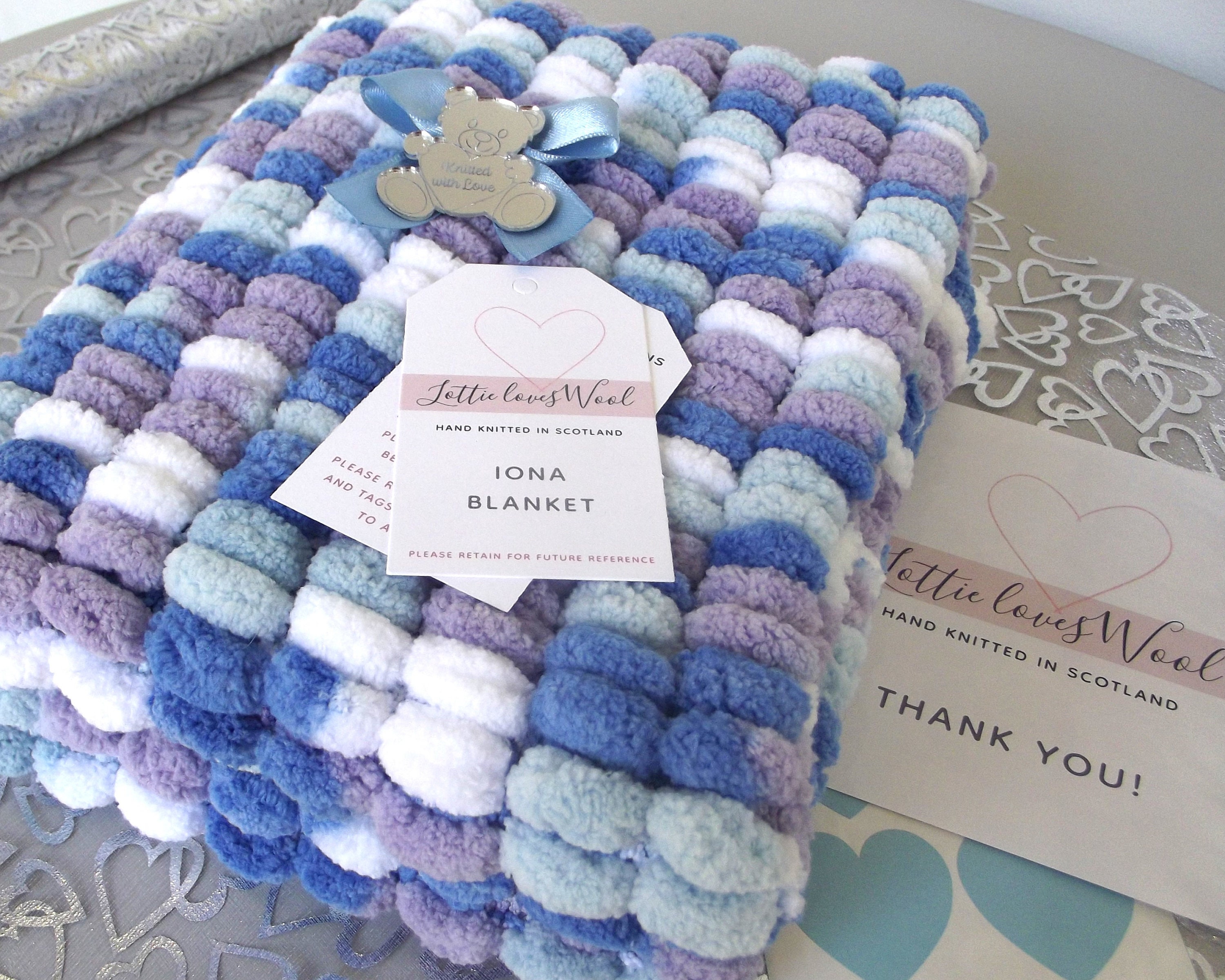 Hand Knitted Pom Pom Baby Blanket: Blues, White, Purple (50x40cms