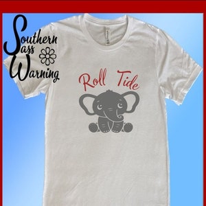 May include: White t-shirt with a gray elephant graphic and the text "Roll Tide" in red.
