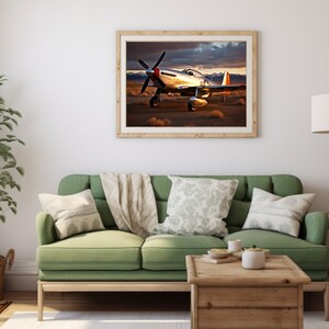 May include: A framed photograph of a silver airplane with red accents, sitting on a runway in a desert landscape. The airplane is facing the camera with its wings spread out. The sky is cloudy and the sun is setting in the background.