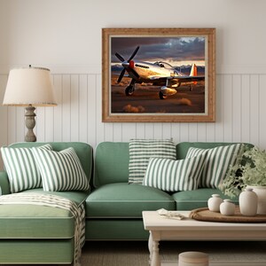 May include: A framed photograph of a silver and red airplane in flight against a cloudy sky. The airplane is a P-51 Mustang, a classic fighter plane from World War II.