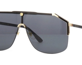 Gucci GG0291S 001 unisex schildzonnebril in zwart/goud met grijze lens 100% UV