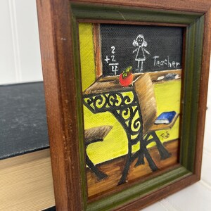Signed folk art piece with warm wood and green trim