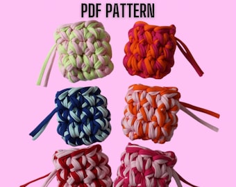 May include: Six colorful crochet Airpods cases in various color combinations, including pink, red, orange, blue, and green. Each case has a loop for attaching to a keychain. The text "CROCHET AIRPODS CASE PDF PATTERN" is at the top.