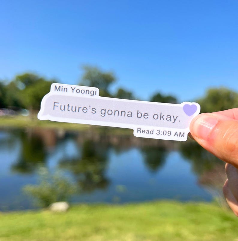 May include: A sticker with a light blue background and white text that reads "Min Yoongi Future's gonna be okay. Read 3:09 AM" with a purple heart icon.