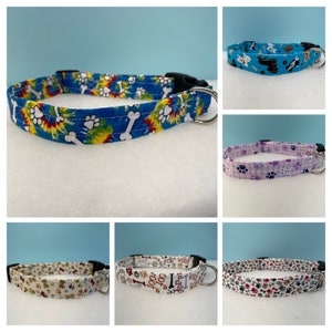 May include: Six different dog collars with various patterns. The collars are made of fabric and have a metal D-ring and a plastic buckle. The patterns include paw prints, bones, and tie-dye.