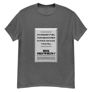 May include: A grey t-shirt with a white rectangular graphic featuring the text "STARSHIP FUEL FOR SMOOTHER HYPER SPACE TRAVEL." and "BIS REFINERY COAXIUM PROCESSING FACILITY INDEPENDENT PNAKOTIC COAST, SAVAREEN, OUTER RIM".