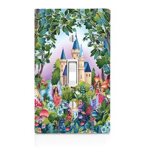 May include: A light switch cover with a whimsical illustration of a fairy tale castle surrounded by a lush forest with fairies and mushrooms. The switch is labeled "OFF".
