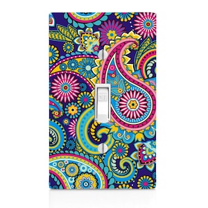 May include: A light switch cover with a colorful paisley pattern in shades of blue, pink, yellow, and green. The switch is labeled "OFF".
