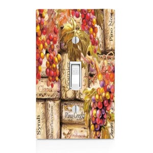 May include: A decorative light switch cover featuring a wine theme. The design includes illustrations of grapes, leaves, and wine corks. The switch is white, with the word "OFF" visible. The background has text that reads "Syrah", "Claret", "Bordeaux", and "Pino Grigio".