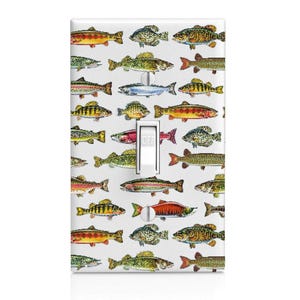 May include: A rectangular light switch cover plate featuring a repeating pattern of various colorful freshwater fish species on a white background. The plate includes a central white toggle switch with the word OFF printed on the switch lever.