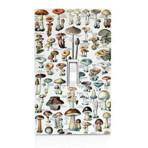 May include: A light switch cover featuring a vintage illustration of various types of mushrooms with their scientific names in French. The illustration is on a white background with a light switch in the center.