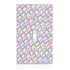 May include: A light switch cover with a colorful rainbow pattern. The cover is white with a light switch in the center. The switch is labeled "OFF".