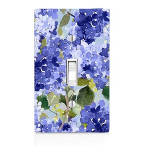May include: A light switch cover with a watercolor floral design featuring blue and green hydrangeas on a light blue background. The switch is labeled "OFF".