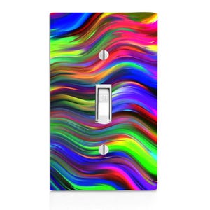 May include: A light switch cover with a colorful abstract design featuring wavy lines in shades of blue, green, red, yellow, and purple.
