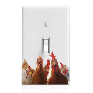 May include: A white light switch cover with a graphic of four chickens looking up at the viewer. The chickens are brown and white with red combs and wattles.