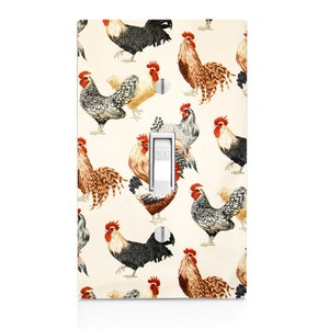 May include: A light switch cover with a pattern of colorful roosters on a cream background. The switch is labeled "OFF".