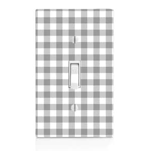 May include: A white light switch cover with a gray and white gingham pattern. The switch cover has a white toggle switch with the word "OFF" printed on it.