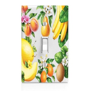 May include: A light switch cover with a colorful fruit design. The design features a variety of fruits, including bananas, pears, oranges, kiwi, and melon. The switch cover is white and has the word "OFF" printed on it.