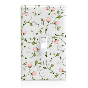 May include: A white light switch cover with a pink rose and green vine pattern. The switch is labeled "OFF".