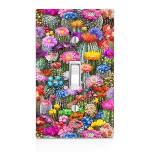 May include: A light switch cover with a colorful cactus and flower design. The switch is labeled "OFF".