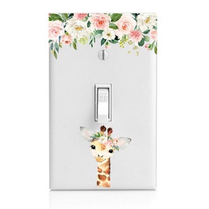 May include: A white light switch cover with a floral design at the top and a watercolor illustration of a giraffe wearing a flower crown in the center. The switch is labeled "OFF".