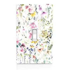 May include: A white light switch cover with a floral pattern. The pattern features watercolor-style flowers in shades of pink, purple, yellow, and green. The switch is labeled "OFF".