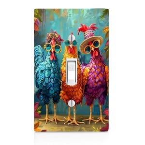 May include: A decorative light switch cover featuring three colorful chickens wearing sunglasses and hats. The chickens are in shades of blue, orange, and purple, with a turquoise background. The switch is in the "OFF" position.