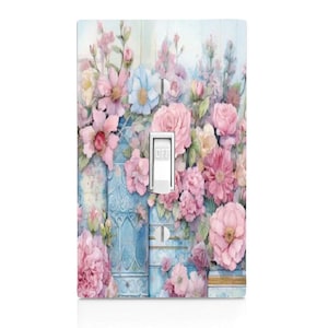 May include: A light switch cover with a floral design featuring pink, blue, and white flowers on a blue and white background. The switch is labeled "OFF".