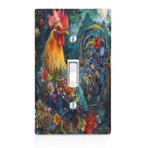 May include: A decorative light switch cover featuring a vibrant watercolor painting of a rooster. The rooster has a red comb and yellow and orange feathers. The background is a dark teal with floral and mountain details. The switch is in the "OFF" position.
