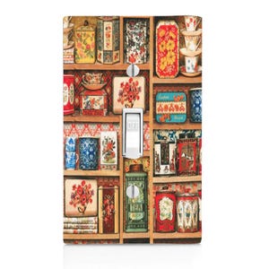 May include: A light switch cover with a vintage design featuring a shelf filled with colorful tea tins, cups, and other decorative items.