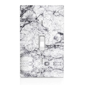 May include: White light switch cover with a marble pattern. The switch is in the off position and says "OFF".