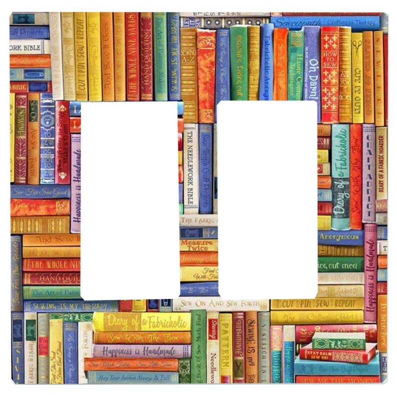 May include: A double light switch wall plate featuring a colourful collage of book spines with sewing and crafting titles. The design includes various vertical books in shades of red, blue, yellow, green, and orange with visible text.