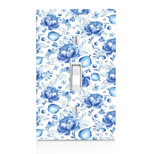 May include: A white light switch cover with a blue and white floral pattern. The switch is labeled "OFF".