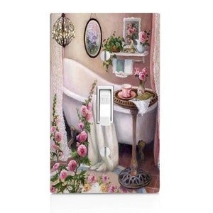 May include: A light switch cover with a vintage bathroom scene. The image features a white bathtub with a towel draped over the side, a small table with a cup of tea and a book, and pink flowers. The switch is labeled "OFF".